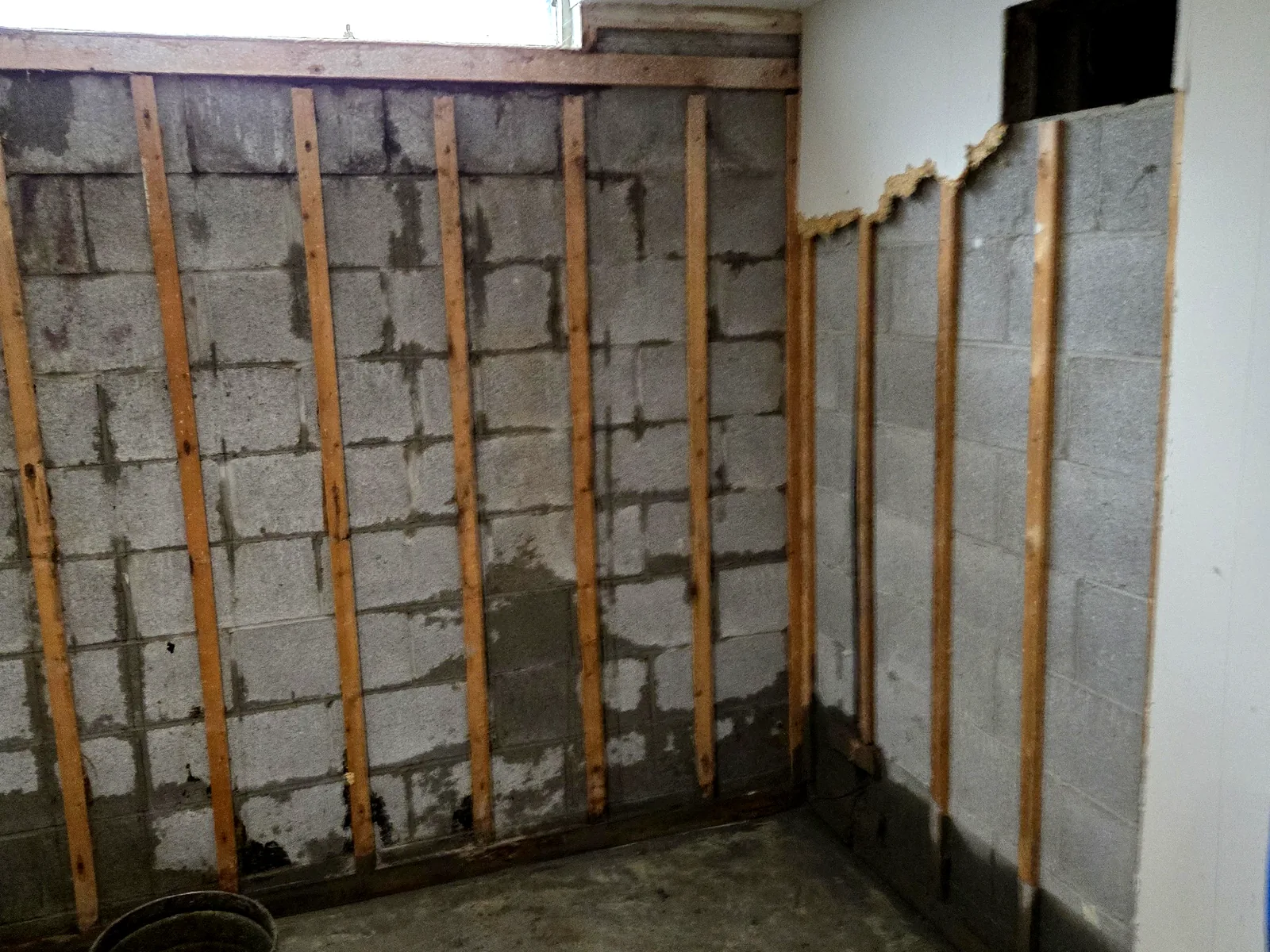 Interior basement wall stabilized with vertical bracing