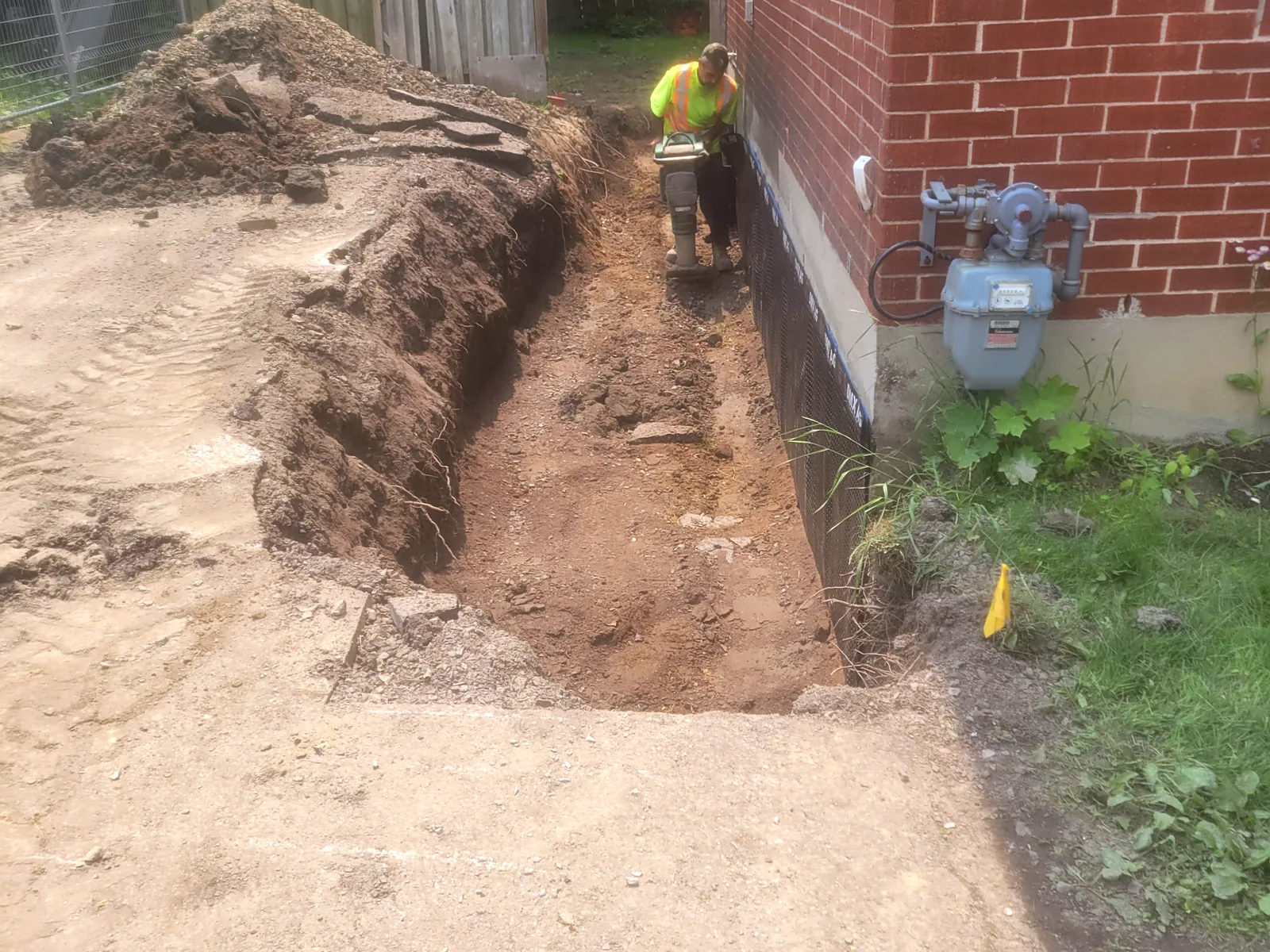 Long excavated trench along an Ottawa foundation during exterior waterproofing